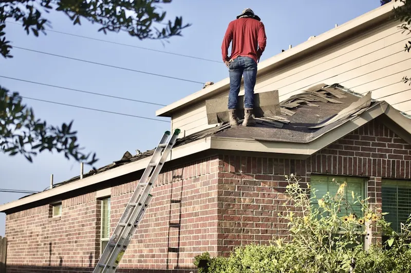 Professional roofer working on a residential roof in Brown Deer